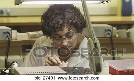 Female jeweller working on piece of jewellery View Large Photo Image Stock Image - Female jeweller working on piece of jewellery. Fotosearch