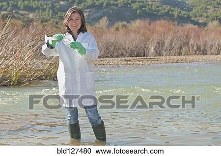 female scientist taking water sample in stream View Large Photo Image Stock Image - female scientist taking water sample in stream. Fotosearch