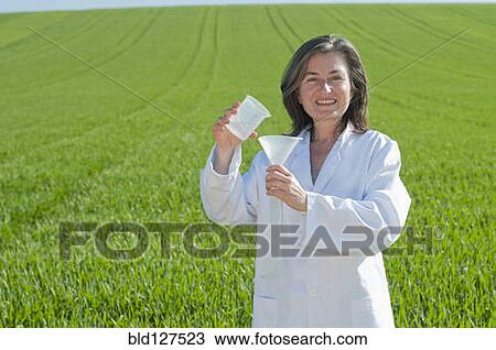 female scientist with test tube in green field View Large Photo Image Stock Image - female scientist with test tube in green field. Fotosearch