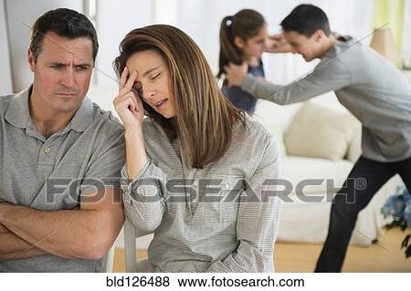 Frustrated Caucasian parents listening to children fight View Large Photo Image Stock Photo - Frustrated Caucasian parents listening to children fight. Fotosearch