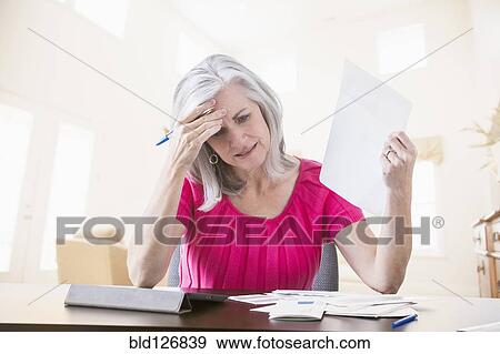 Frustrated Caucasian woman paying bills online View Large Photo Image Stock Photo - Frustrated Caucasian woman paying bills online. Fotosearch