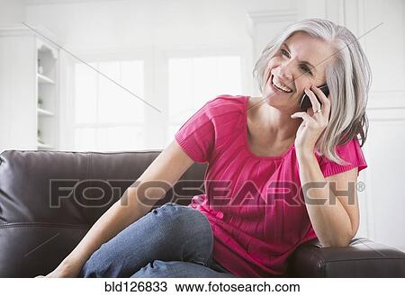 Happy Caucasian woman talking on cell phone View Large Photo Image Stock Image - Happy Caucasian woman talking on cell phone. Fotosearch