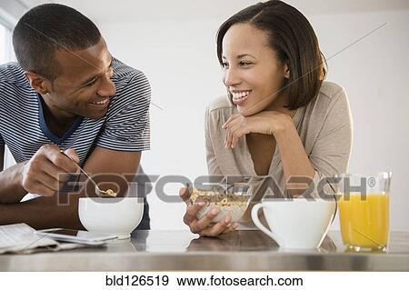 Stock Photo - Happy couple eating cereal. Fotosearch