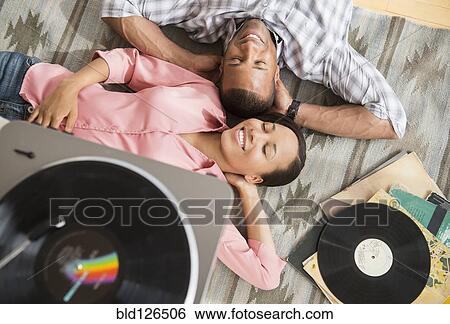 Happy couple on rug listening to record player View Large Photo Image Stock Photograph - Happy couple on rug listening to record player. Fotosearch