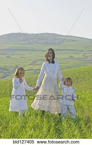 happy family in green fields View Large Photo Image Stock Photography - happy family in green fields. Fotosearch