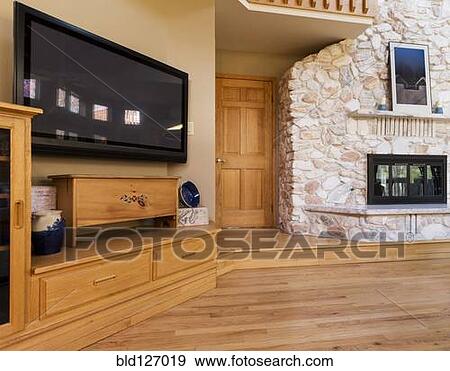 Hardwood floor and cupboards under flat screen TV View Large Photo Image Stock Photo - Hardwood floor and cupboards under flat screen TV. Fotosearch