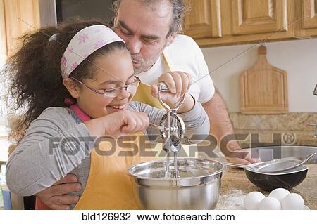 Hispanic father and daughter baking in kitchen View Large Photo Image Stock Image - Hispanic father and daughter baking in kitchen. Fotosearch