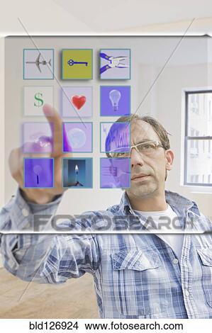 Picture - Hispanic man using mobile apps on virtual screen. Fotosearch