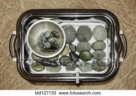 Hot stones and warmer on tray in spa View Large Photo Image Stock Image - Hot stones and warmer on tray in spa. Fotosearch