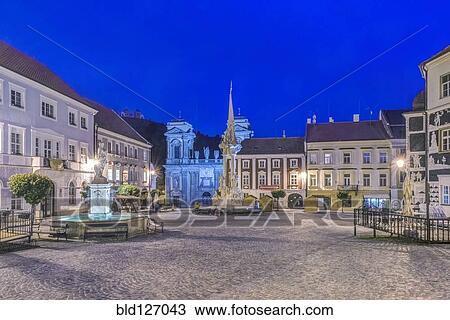 Stock Image - Illuminated piazza at dawn, Prague, Central Bohemia, Czech Republic. Fotosearch