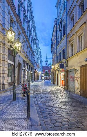 Illuminated streetlamp on cobblestone alley at dawn, Prague, Central Bohemia, Czech Republic View Large Photo Image Stock Photograph - Illuminated streetlamp on cobblestone alley at dawn, Prague, Central Bohemia, Czech Republic. Fotosearch