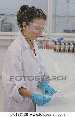 Lab technician reading report in laboratory View Large Photo Image Stock Photo - Lab technician reading report in laboratory. Fotosearch