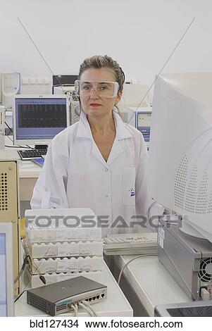 Lab technician standing at counter in laboratory View Large Photo Image Picture - Lab technician standing at counter in laboratory. Fotosearch