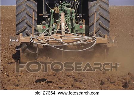 Low Section of a Tractor Ploughing the Soil in a Field View Large Photo Image Picture - Low Section of a Tractor Ploughing the Soil in a Field. Fotosearch