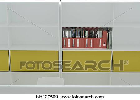 Stock Photo - Magazines on coloured shelf in office building. Fotosearch