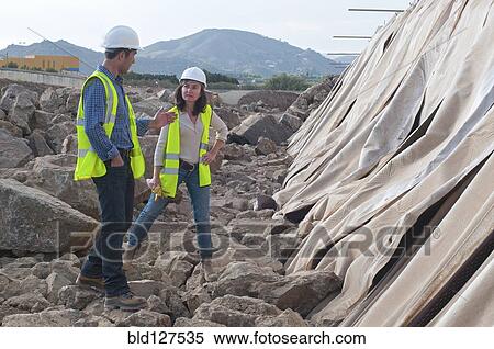 male and female engineers in construction site View Large Photo Image Stock Photography - male and female engineers in construction site. Fotosearch