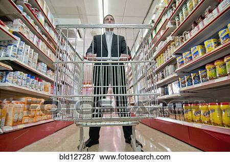 man behind empty shopping trolley View Large Photo Image Stock Photo - man behind empty shopping trolley. Fotosearch