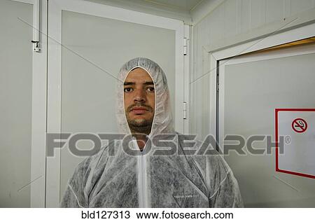 Stock Image - man in safety coverall in food processing plant. Fotosearch