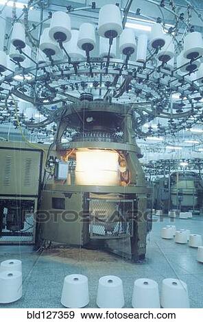 Man operating machine in textile factory View Large Photo Image Stock Photo - Man operating machine in textile factory. Fotosearch