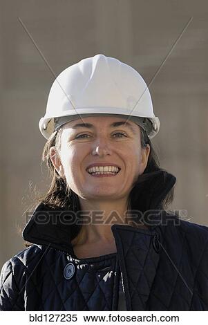 Mature female engineer wearing hard hat smiling portrait View Large Photo Image Stock Photography - Mature female engineer wearing hard hat smiling portrait. Fotosearch