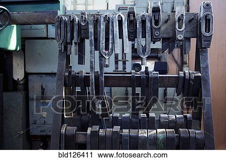 Metal parts hanging in metal shop View Large Photo Image Stock Image - Metal parts hanging in metal shop. Fotosearch