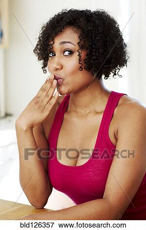 Mixed race woman covering her mouth View Large Photo Image Stock Photo - Mixed race woman covering her mouth. Fotosearch