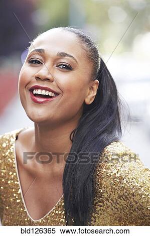 Stock Photography - Mixed race woman laughing outdoors. Fotosearch