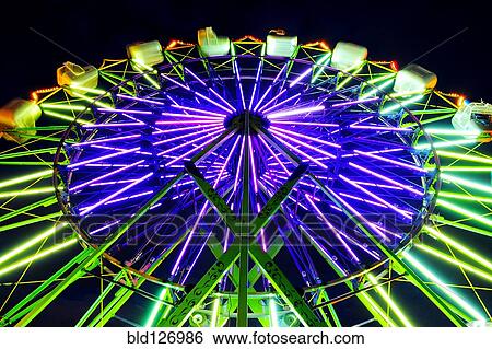 Neon Ferris Wheel ride at amusement park at night View Large Photo Image Stock Photograph - Neon Ferris Wheel ride at amusement park at night. Fotosearch