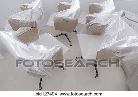 New office chairs covered in protective plastic sheets View Large Photo Image Picture - New office chairs covered in protective plastic sheets. Fotosearch