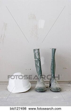 Pair of dirty work boots and white hard hat View Large Photo Image Stock Photo - Pair of dirty work boots and white hard hat. Fotosearch