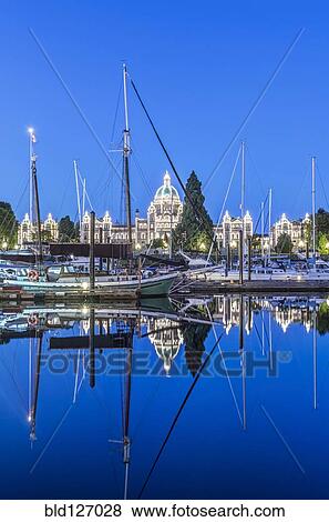 Parliament Buildings and harbor illuminated at dawn, Victoria, British Columbia, Canada View Large Photo Image Stock Photo - Parliament Buildings and harbor illuminated at dawn, Victoria, British Columbia, Canada. Fotosearch