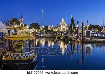 Stock Photograph - Parliament Buildings and harbor illuminated at dusk, Victoria, British Columbia, Canada. Fotosearch