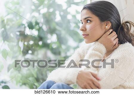 Pensive Hispanic woman looking out window View Large Photo Image Stock Image - Pensive Hispanic woman looking out window. Fotosearch