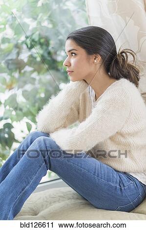 Pensive Hispanic woman looking out window View Large Photo Image Stock Image - Pensive Hispanic woman looking out window. Fotosearch