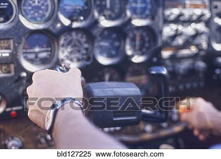 Stock Photography - Pilot handling controls close-up (focus on hand). Fotosearch