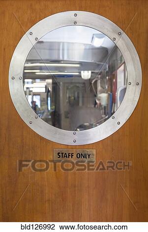 Porthole above Staff Only sign on ship door View Large Photo Image Stock Image - Porthole above Staff Only sign on ship door. Fotosearch