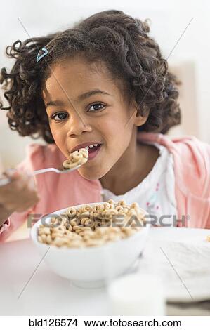 Portrait of African American girl eating cereal View Large Photo Image Picture - Portrait of African American girl eating cereal. Fotosearch
