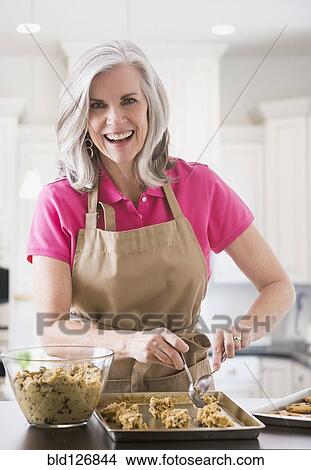 Picture - Portrait of Caucasian woman baking cookies. Fotosearch