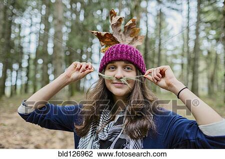 Portrait of Caucasian woman playing with leaves View Large Photo Image Stock Image - Portrait of Caucasian woman playing with leaves. Fotosearch