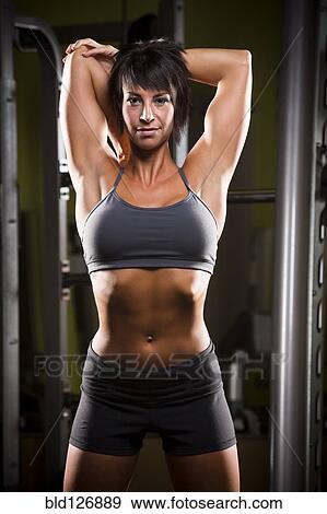 Stock Photo - Portrait of Caucasian woman stretching in gym. Fotosearch