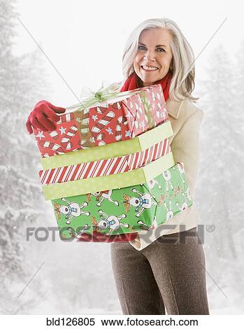 Portrait of Caucasian woman with Christmas gifts View Large Photo Image Stock Photography - Portrait of Caucasian woman with Christmas gifts. Fotosearch