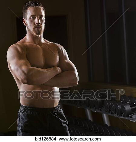Portrait of confident Caucasian man with bare chest in gym View Large Photo Image Picture - Portrait of confident Caucasian man with bare chest in gym. Fotosearch