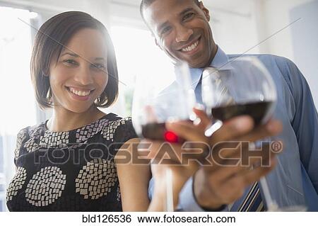 Portrait of happy couple toasting wine glasses View Large Photo Image Stock Photograph - Portrait of happy couple toasting wine glasses. Fotosearch