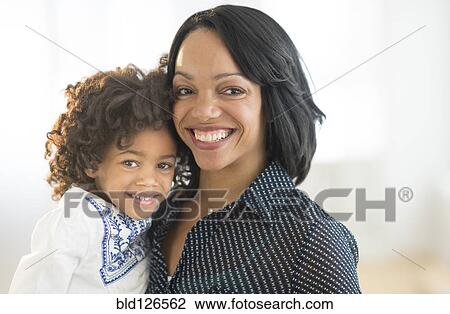 Stock Image - Portrait of smiling African American mother and daughter. Fotosearch