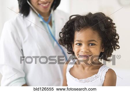 Portrait of smiling African American girl with doctor View Large Photo Image Stock Photography - Portrait of smiling African American girl with doctor. Fotosearch