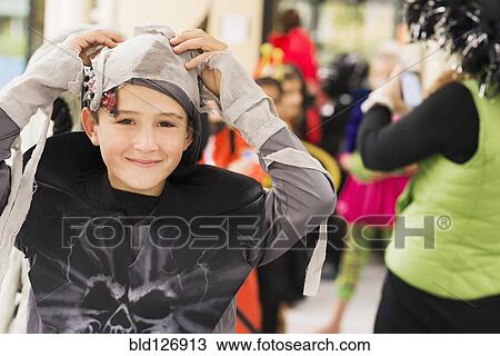 Stock Image - Portrait of smiling Caucasian boy in mummy costume. Fotosearch