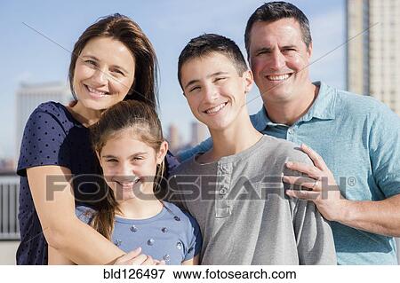 Portrait of smiling Caucasian family outdoors View Large Photo Image Stock Photo - Portrait of smiling Caucasian family outdoors. Fotosearch