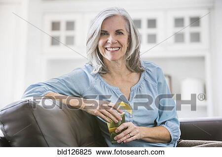 Portrait of smiling Caucasian woman drinking iced tea View Large Photo Image Stock Photography - Portrait of smiling Caucasian woman drinking iced tea. Fotosearch