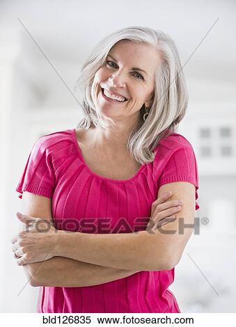 Portrait of smiling Caucasian woman with arms crossed View Large Photo Image Stock Photography - Portrait of smiling Caucasian woman with arms crossed. Fotosearch