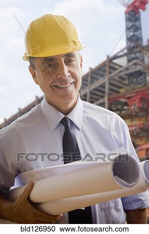 Portrait of smiling Hispanic architect at construction site View Large Photo Image Stock Image - Portrait of smiling Hispanic architect at construction site. Fotosearch